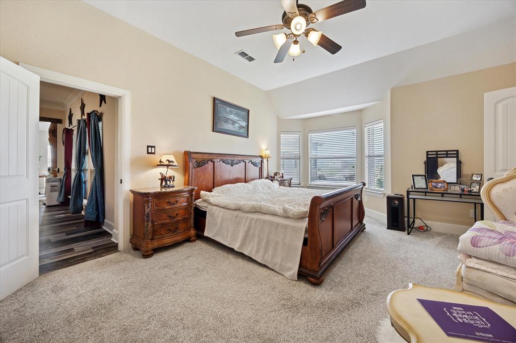 119 George Owens Road Ponder, TX 76259 - Photo 14 of 26 Spacious room featuring carpet flooring, a vaulted ceiling with a ceiling fan, and a bay window configuration