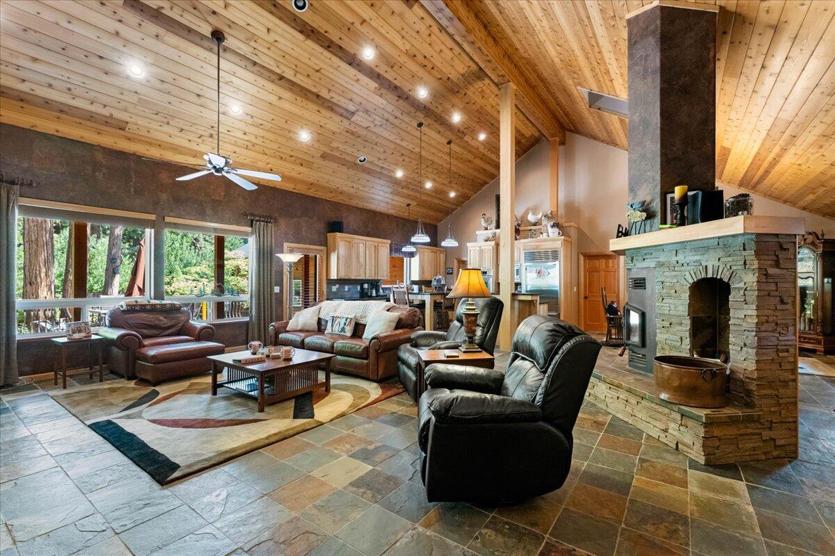 1601 Timber Hills Road Mount Shasta, CA 96067 - Photo 34 of 74 a living room with furniture a large window and a fireplace
