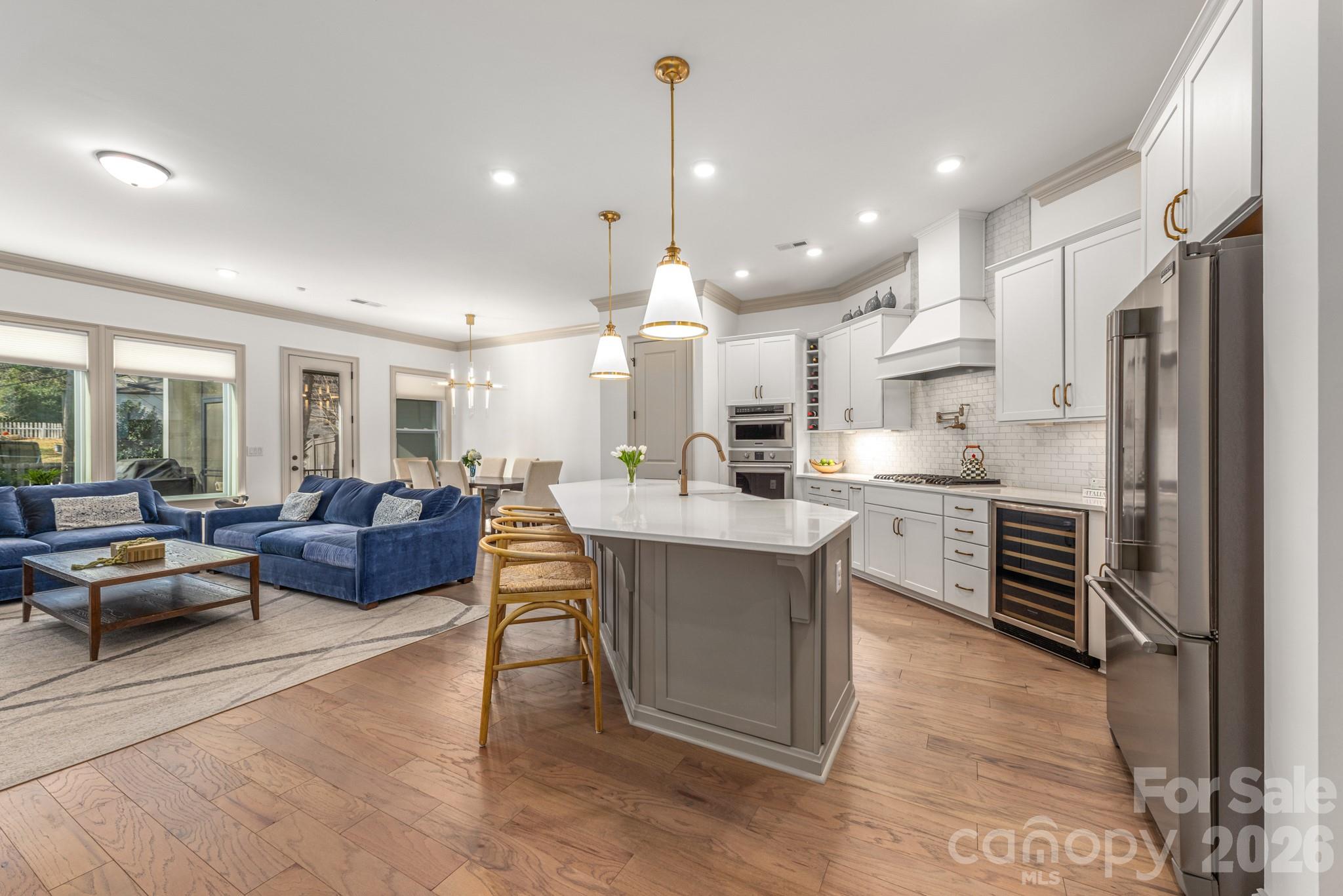 2547 Barry Street Charlotte, NC 28205 - Photo 13 of 45 a large kitchen with kitchen island a large counter space a sink stainless steel appliances and cabinets
