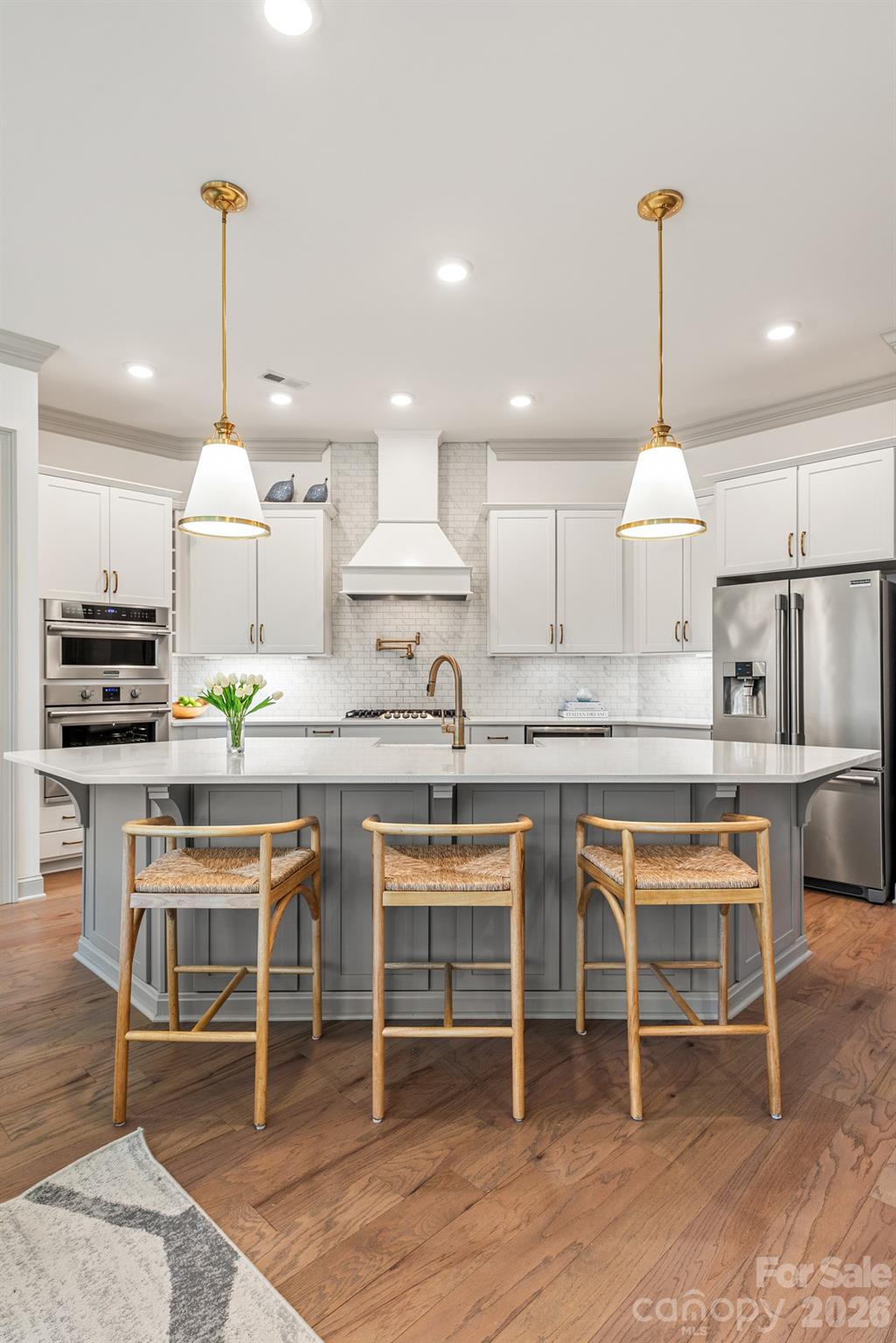 2547 Barry Street Charlotte, NC 28205 - Photo 19 of 45 a kitchen with cabinets a sink and chairs