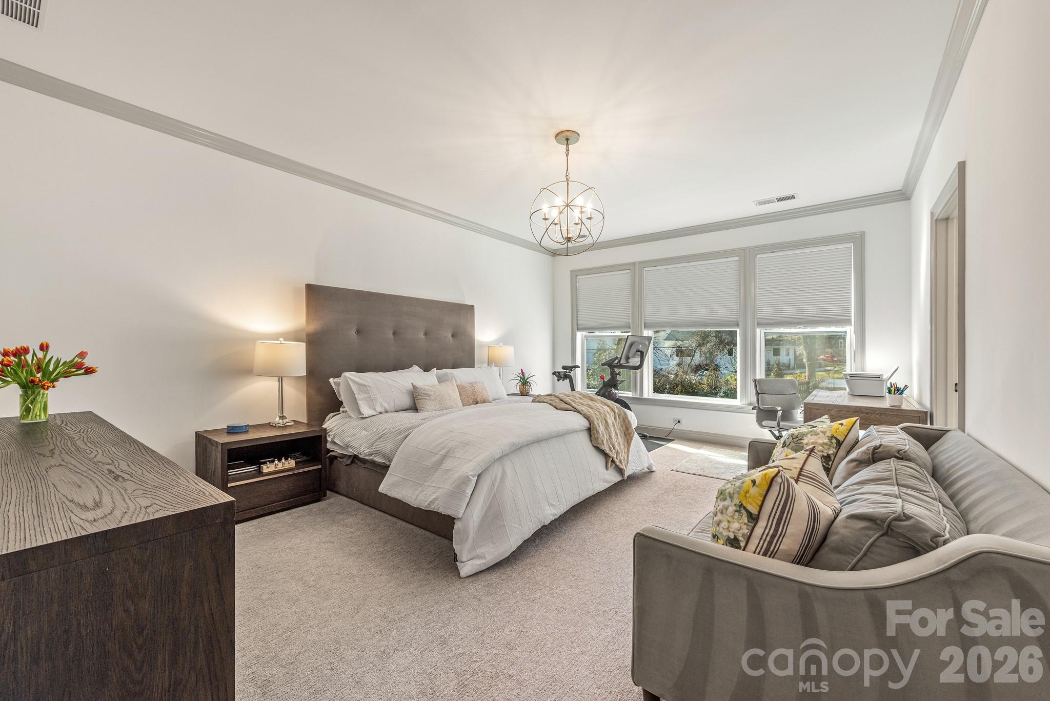 2547 Barry Street Charlotte, NC 28205 - Photo 28 of 45 a bedroom with a bed couch chandelier and window