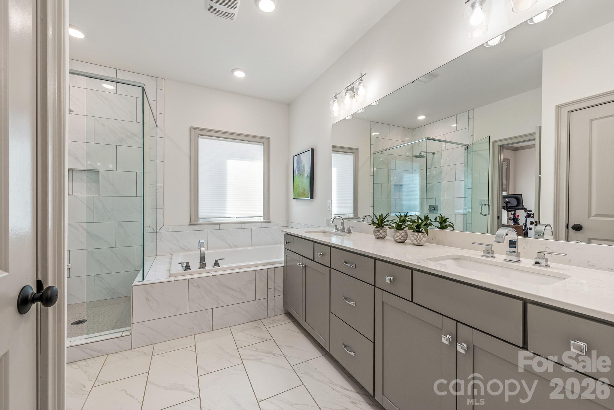 2547 Barry Street Charlotte, NC 28205 - Photo 31 of 45 a spacious bathroom with a bathtub shower sink and mirror
