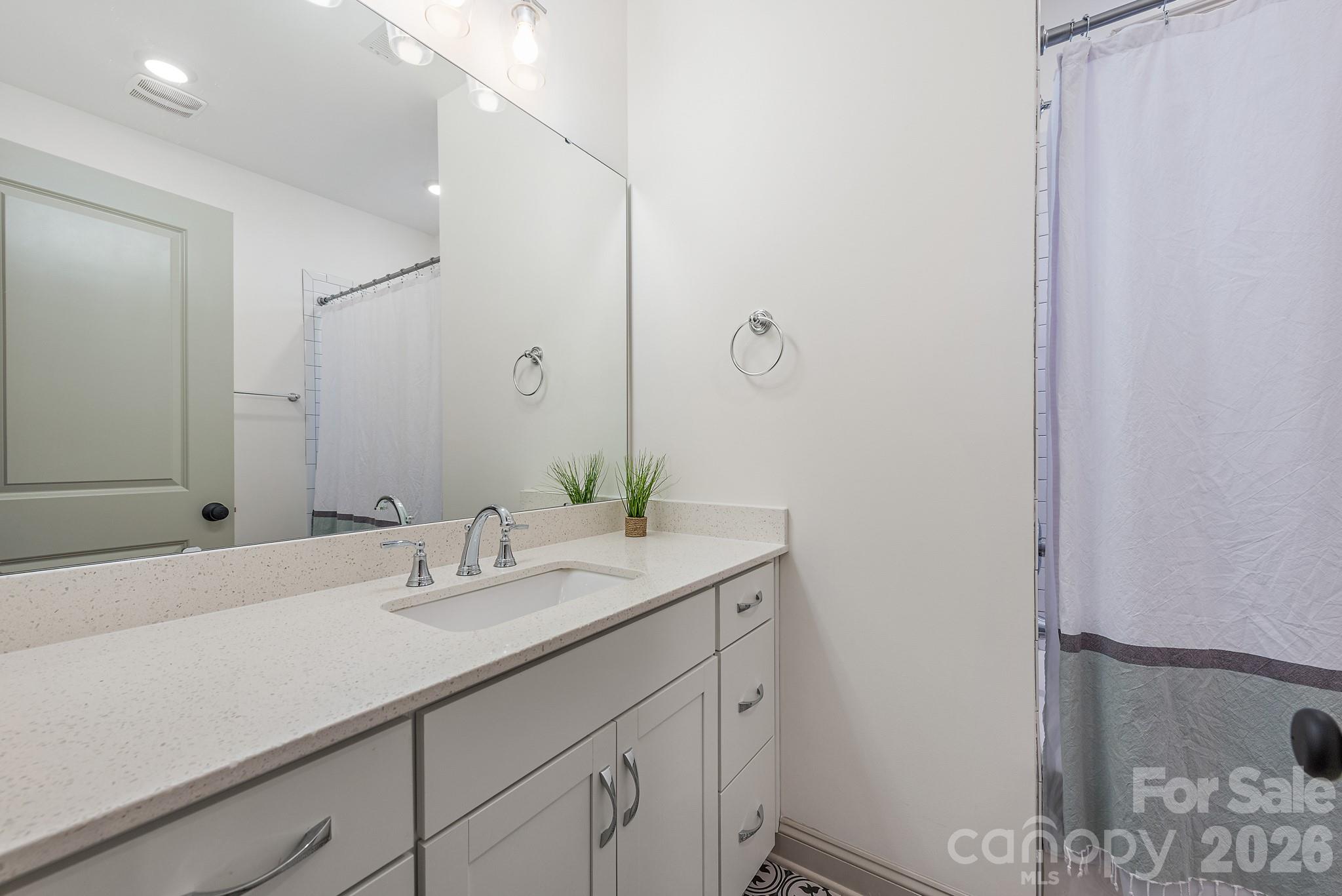 2547 Barry Street Charlotte, NC 28205 - Photo 36 of 45 a bathroom with a sink and a mirror