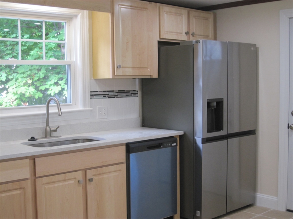 139 Readville Street Boston, MA 02136 - Photo 17 of 31 a kitchen with stainless steel appliances white cabinets and a refrigerator