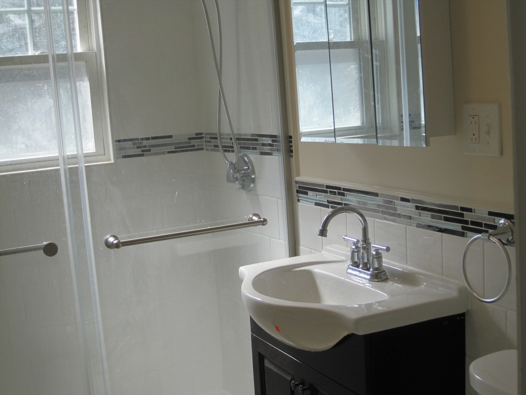 139 Readville Street Boston, MA 02136 - Photo 18 of 31 a bathroom with a sink and a mirror