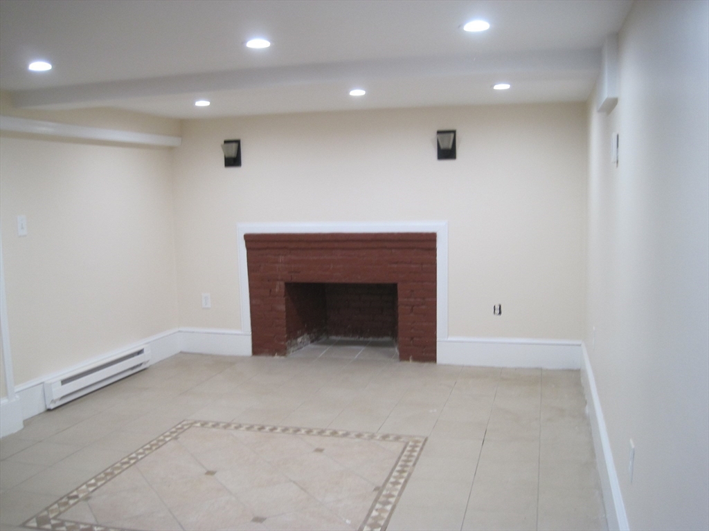 139 Readville Street Boston, MA 02136 - Photo 24 of 31 an empty room with a fireplace