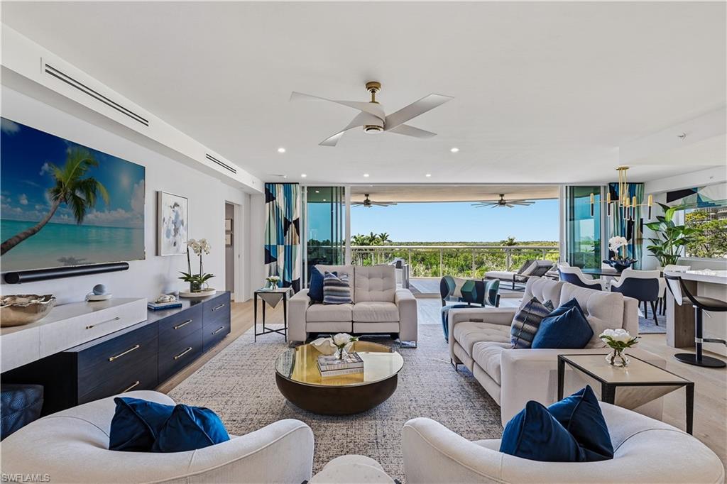 13935 Old Coast Road, Unit 406 Naples, FL 34110 - Photo 10 of 49 Living room with expansive windows, light wood finished floors, and recessed lighting