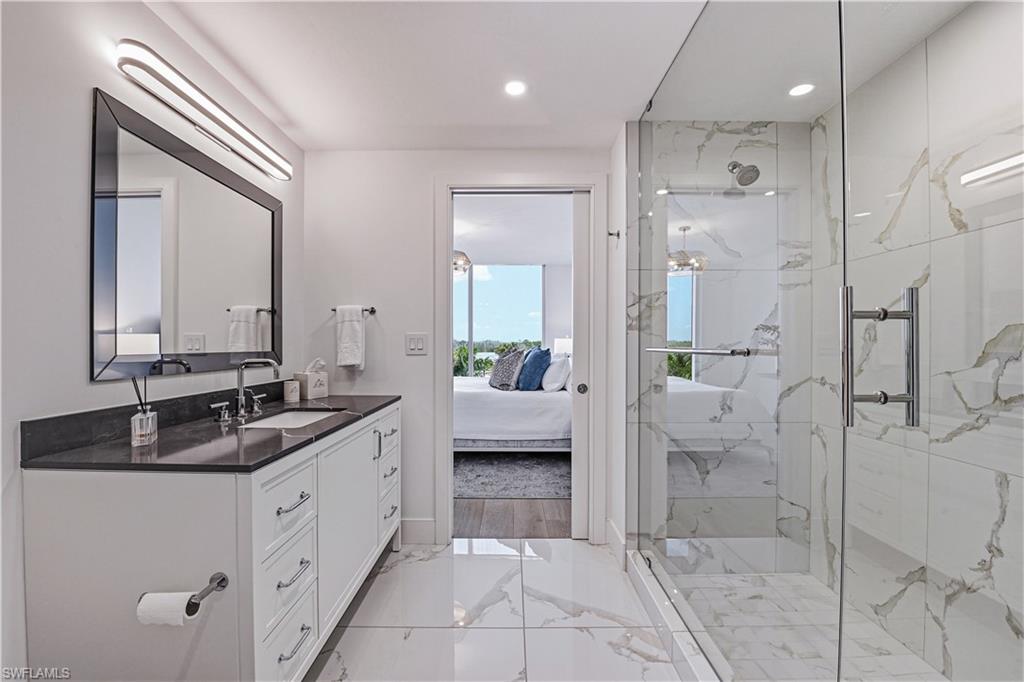 13935 Old Coast Road, Unit 406 Naples, FL 34110 - Photo 16 of 49 Full bathroom featuring vanity, a marble finish shower, ensuite bathroom, recessed lighting, and light marble finish flooring