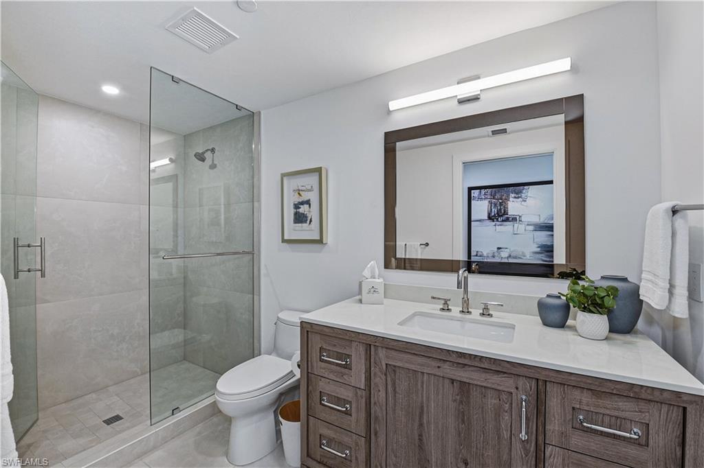 13935 Old Coast Road, Unit 406 Naples, FL 34110 - Photo 18 of 49 Bathroom featuring a stall shower and vanity