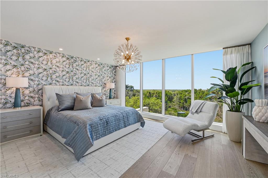 13935 Old Coast Road, Unit 406 Naples, FL 34110 - Photo 20 of 49 Bedroom with a chandelier, light wood-style flooring, and wallpapered walls