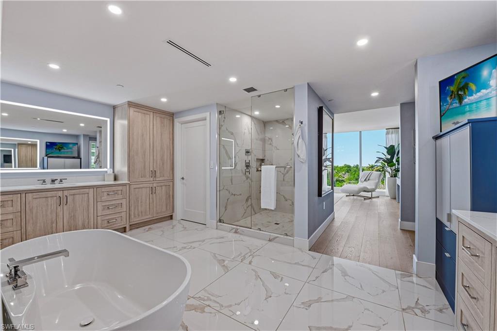 13935 Old Coast Road, Unit 406 Naples, FL 34110 - Photo 24 of 49 Full bathroom featuring vanity, a freestanding bath, a marble finish shower, and recessed lighting