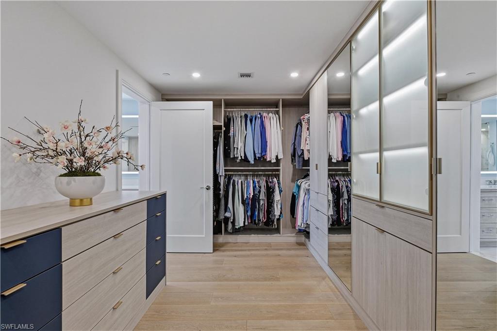 13935 Old Coast Road, Unit 406 Naples, FL 34110 - Photo 25 of 49 Walk in closet featuring light wood-style floors