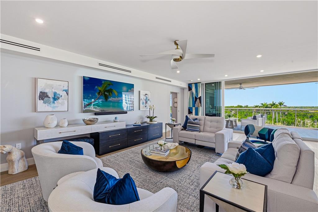 13935 Old Coast Road, Unit 406 Naples, FL 34110 - Photo 9 of 49 Living area with recessed lighting, ceiling fan, and wood finished floors