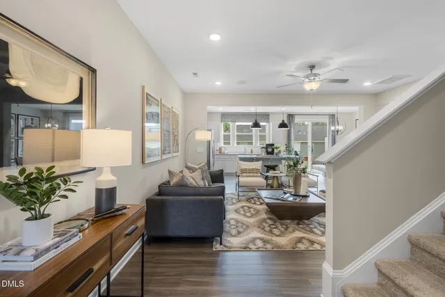 a living room with furniture and a chandelier