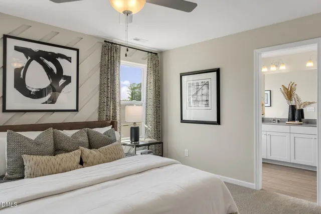 a bedroom with a bed couch and painting on the wall