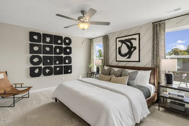 a bedroom with a bed and a wall painting