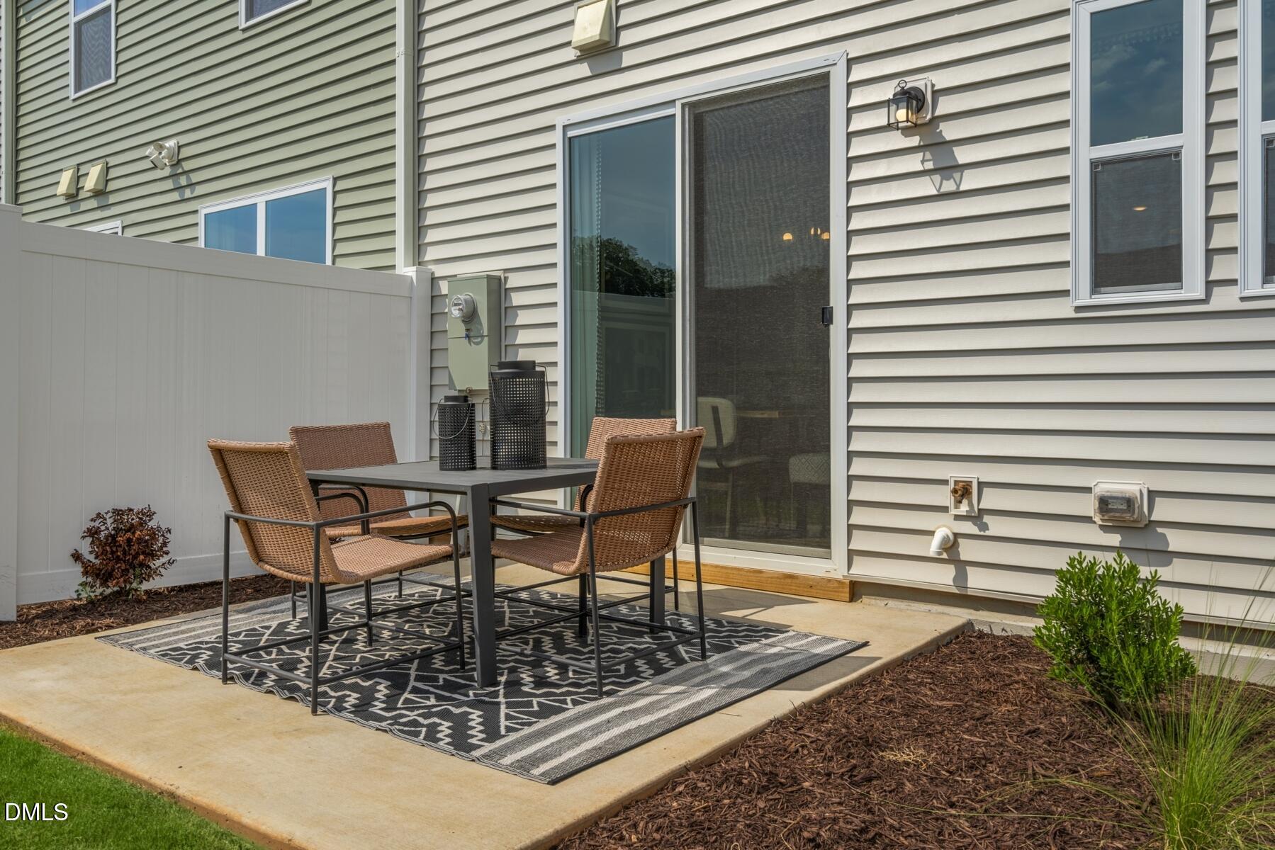 128 Lennei Lane Garner, NC 27529 - Photo 27 of 30 a table and chairs in front of a house