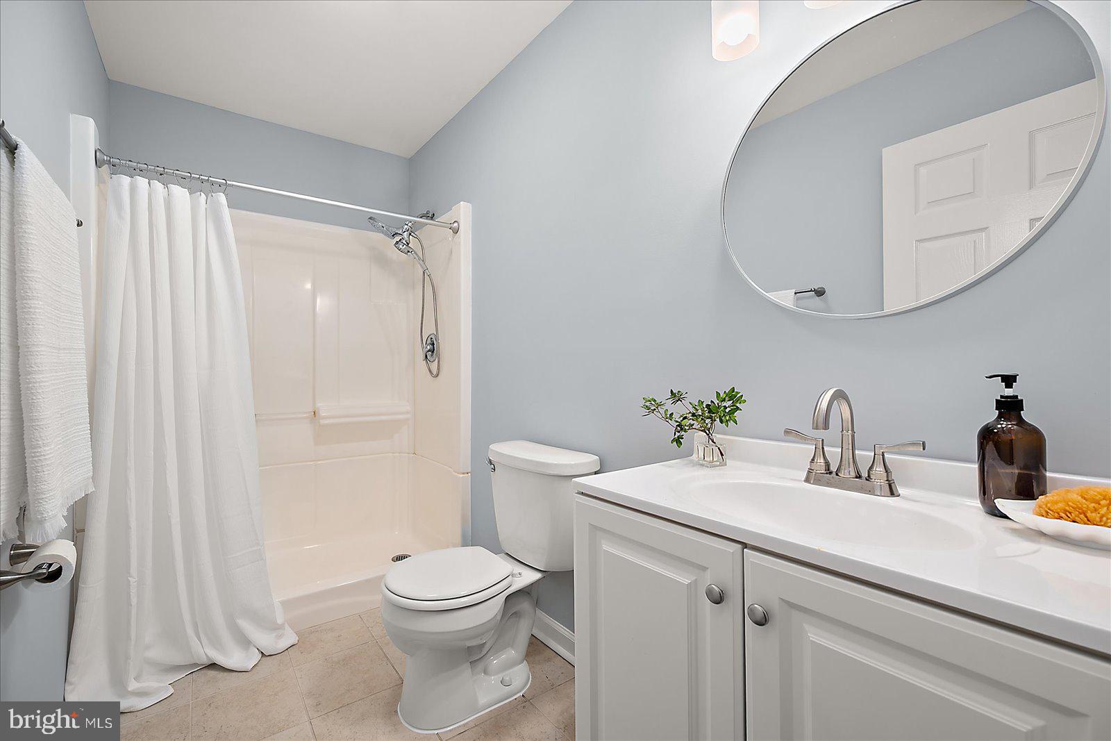 135 Jamestown Road, Unit 18A Ocean City, MD 21842 - Photo 32 of 63 a bathroom with a sink a toilet and a mirror