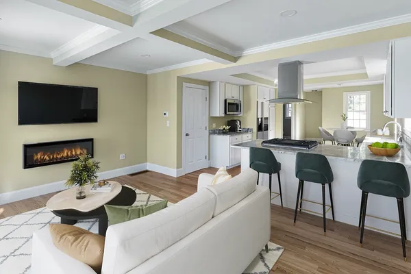 a living room with furniture a flat screen tv and a fireplace
