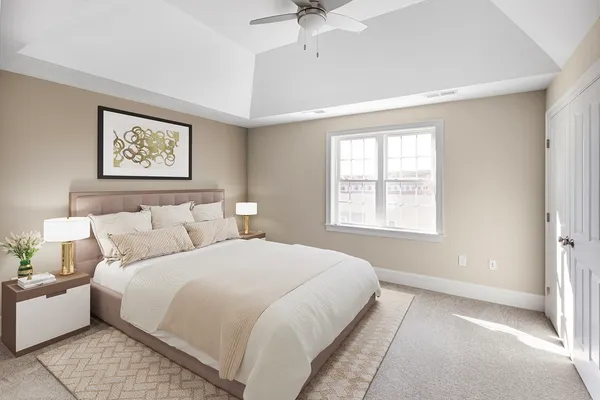 a bedroom with a large bed and a window