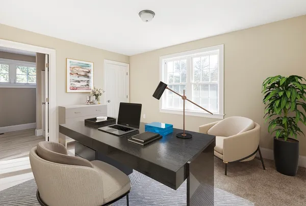 a work room with furniture and a potted plant