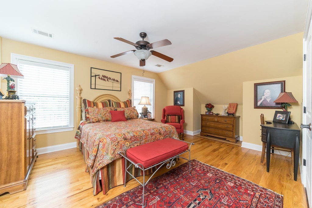 2045 Midway Road Lizella, GA 31052 - Photo 40 of 66 a bedroom with a bed a table and chair with the wooden floor