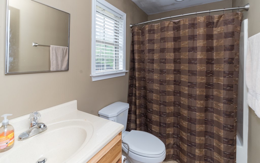 2045 Midway Road Lizella, GA 31052 - Photo 50 of 66 a white toilet sitting next to a bathroom sink