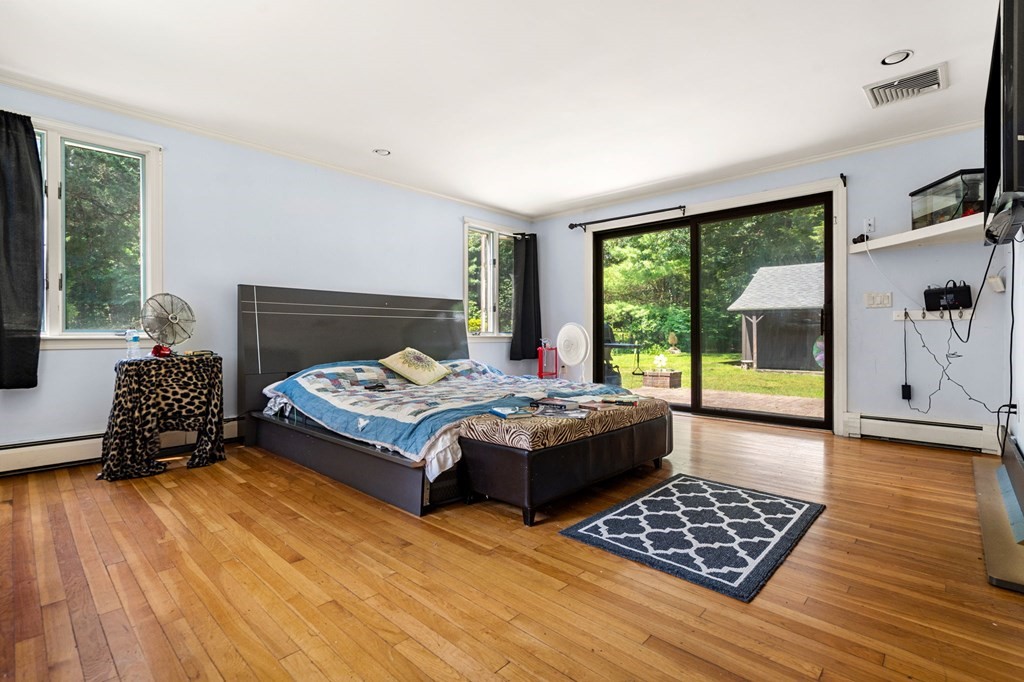 10 Beaver Pond Road Beverly, MA 01915 - Photo 7 of 39 a bedroom with a bed and wooden floor