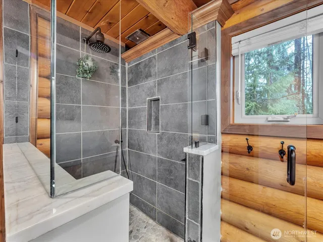 a bathroom with a shower and a sink