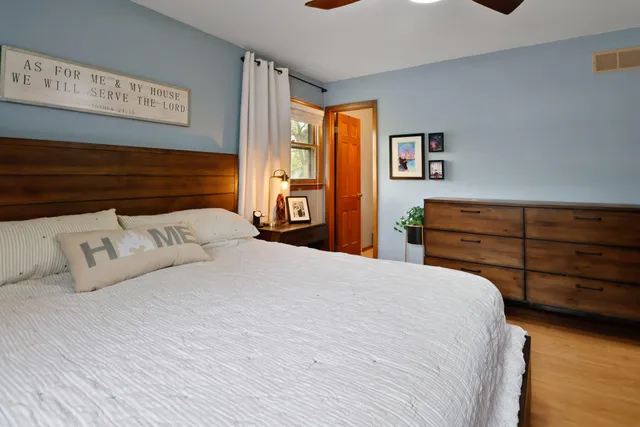 a bedroom with a bed and a dresser