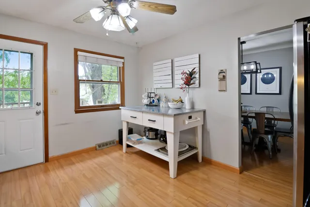 a view of a workspace with furniture and window