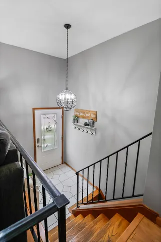 a view of a hallway with wooden floor and stairs