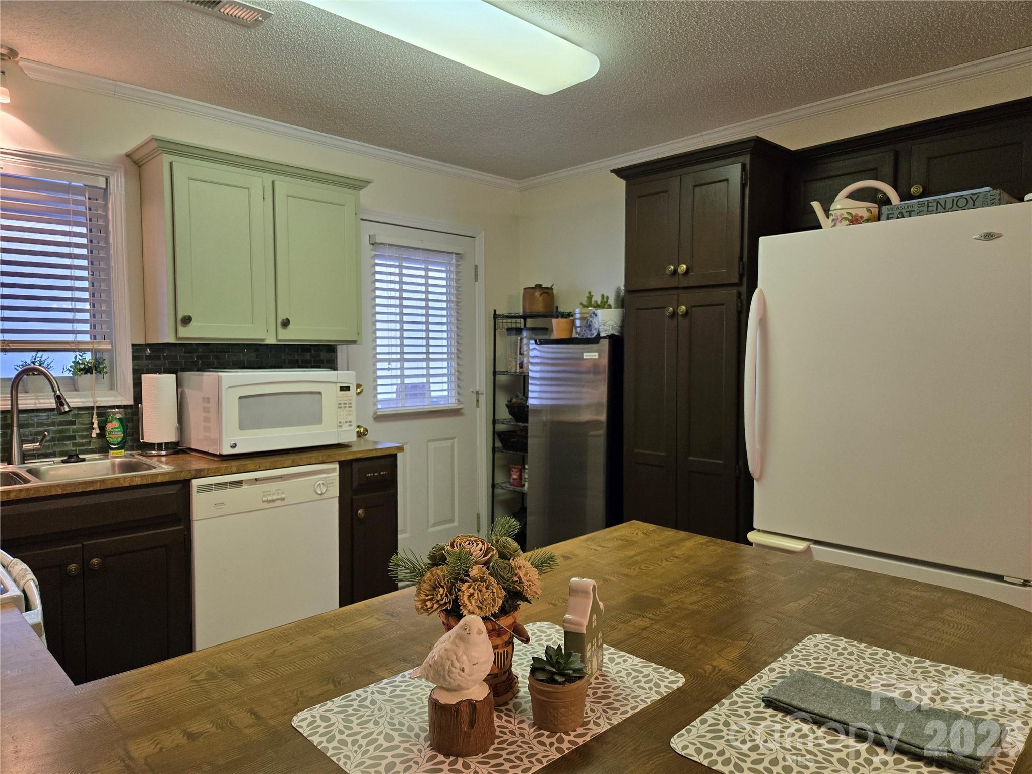 505 2nd St Place Northeast, Unit D2 Conover, NC 28613 - Photo 8 of 21 a kitchen with a refrigerator and a stove top oven