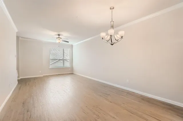 a view of a room with wooden floor and white walls