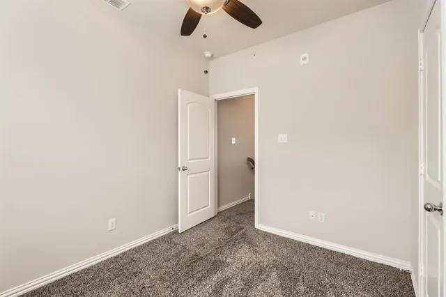 an empty room with closet and white walls