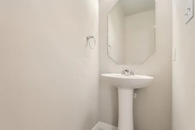 a bathroom with a sink a mirror and toilet