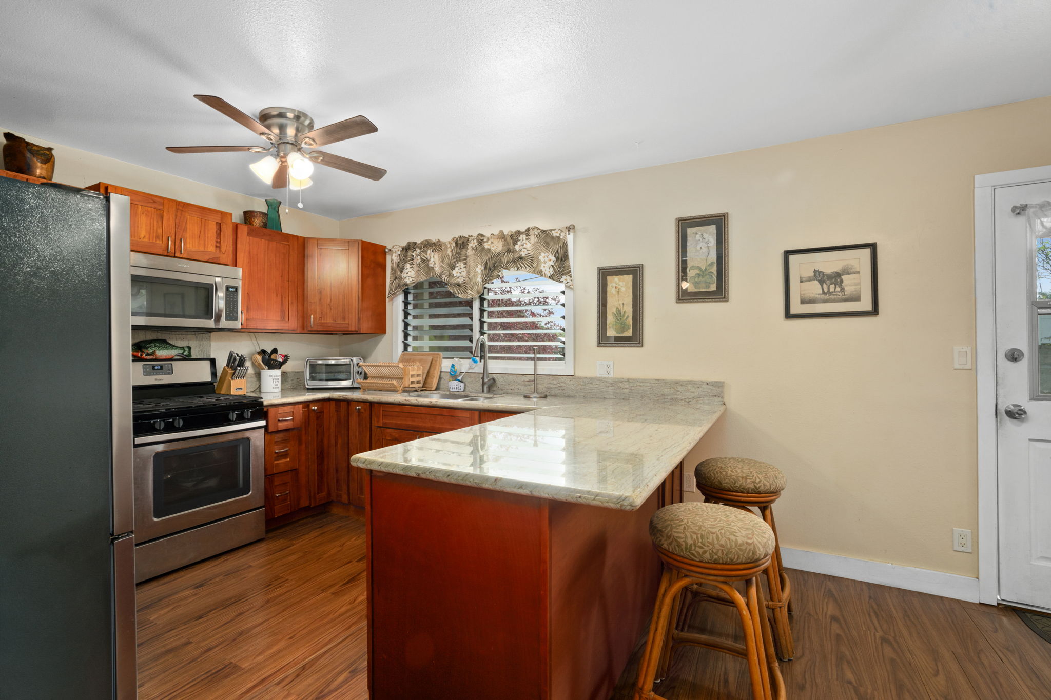 4906 Aliali Road Kapaa, HI 96746 - Photo 25 of 30 a kitchen with granite countertop a stove cabinets and wooden floor