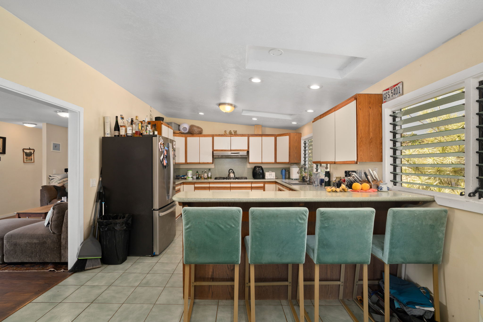4906 Aliali Road Kapaa, HI 96746 - Photo 4 of 30 a kitchen with a table chairs refrigerator and cabinets