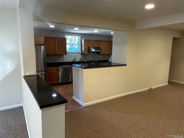 a kitchen with stainless steel appliances granite countertop a sink and a stove