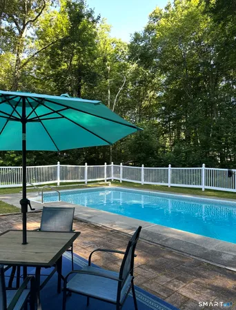 a view of a table and chairs under an umbrella