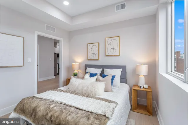 a bedroom with a bed and a lamp