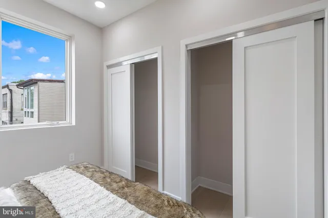 a bedroom with a bed and a mirror