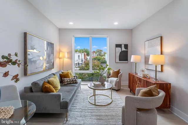 a living room with furniture and a lamp