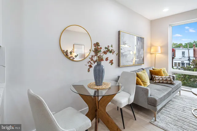 a dining room with furniture and a mirror