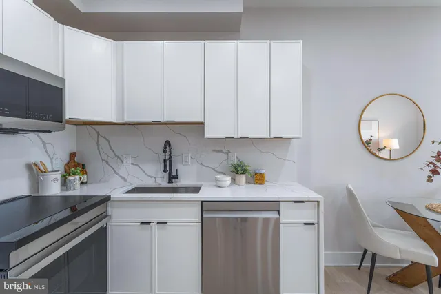 a kitchen with a sink cabinets and window