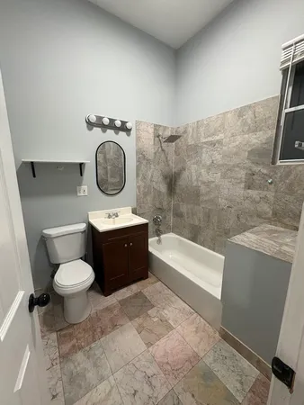 a bathroom with a toilet a sink and bathtub