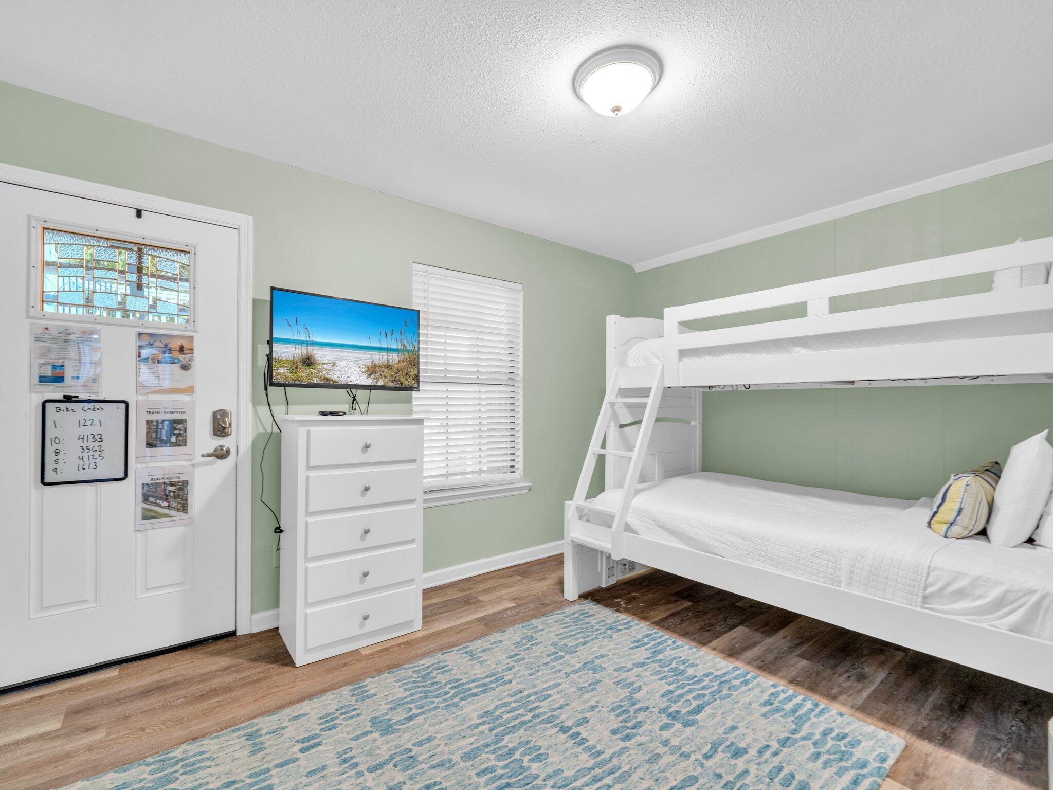 50 Gossamer Lane, Unit 10 Inlet Beach, FL 32461 - Photo 19 of 46 a bedroom with a bed and wooden floor