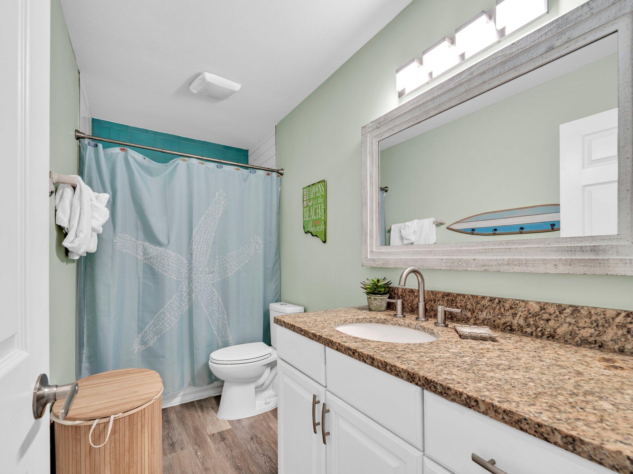 50 Gossamer Lane, Unit 10 Inlet Beach, FL 32461 - Photo 22 of 46 a bathroom with a granite countertop sink a toilet and a mirror