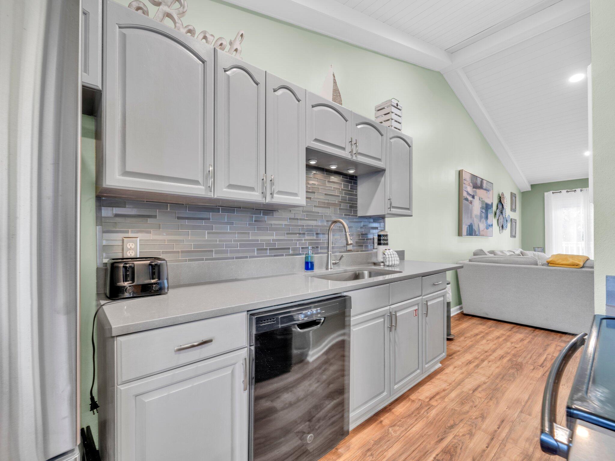 50 Gossamer Lane, Unit 10 Inlet Beach, FL 32461 - Photo 6 of 46 a kitchen with stainless steel appliances granite countertop a sink stove and cabinets
