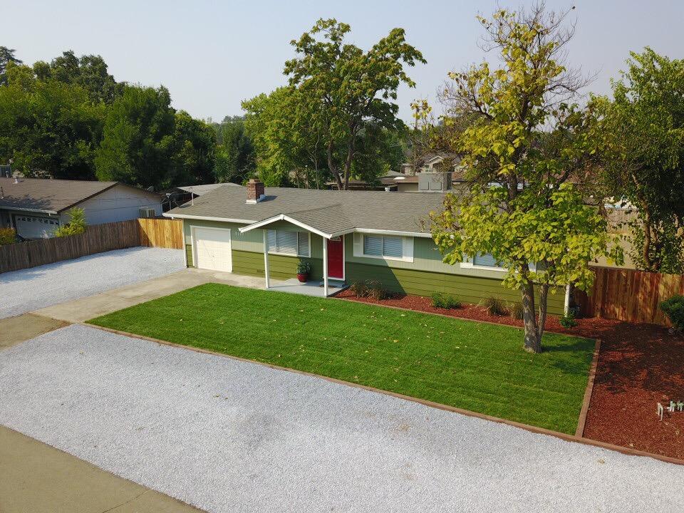 6560 Riverside Drive Redding, CA 96001 - Photo 1 of 15 a view of a house with a yard and tree s